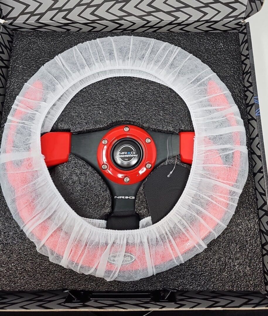 Steering wheel covered with a transparent plastic protective cover.
