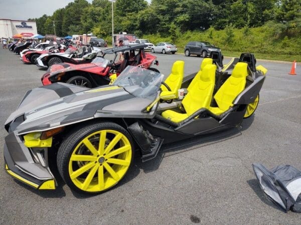 A black and yellow vehicle with four seats