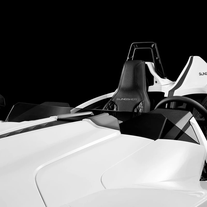 Close-up of a sleek white sports car interior with racing-style seats.