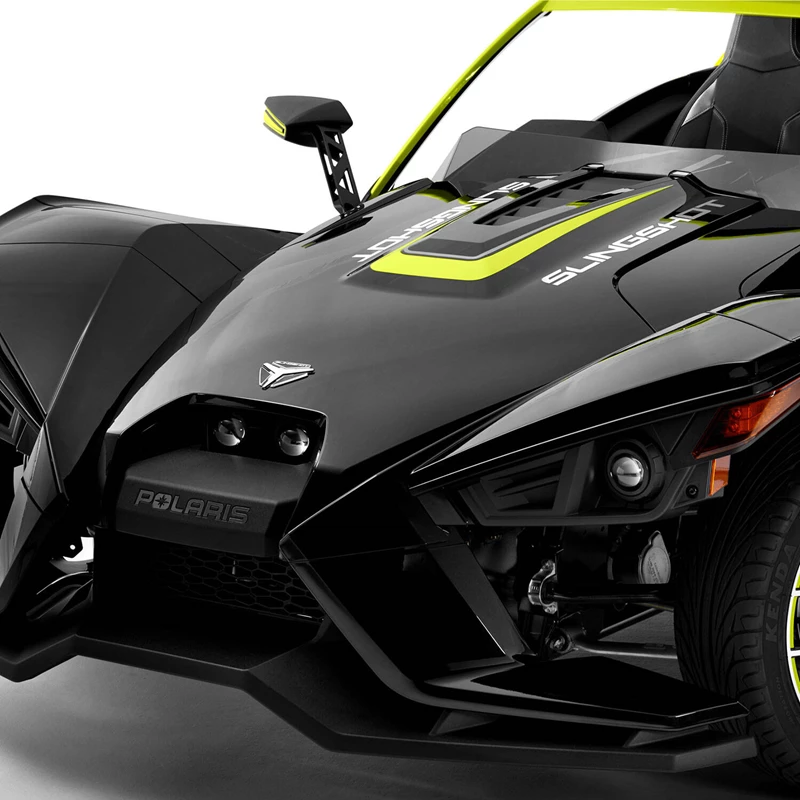 Close-up of a sleek black three-wheeled motorcycle with neon green accents.