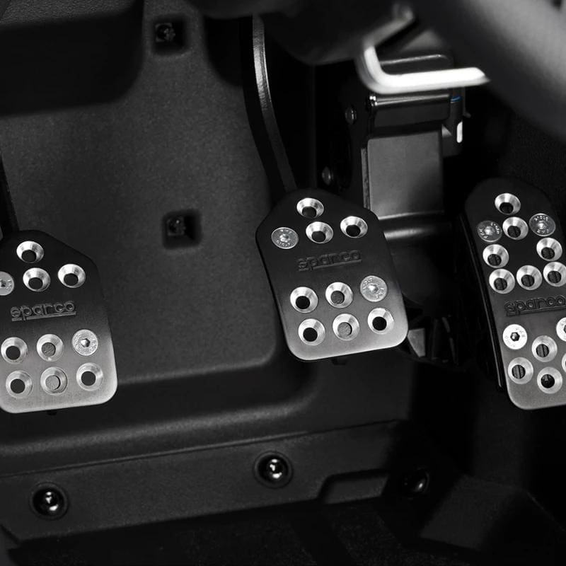 Close-up of car pedals with a sporty metallic design.