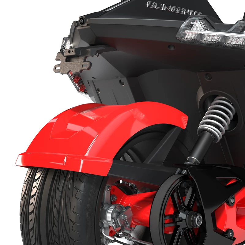 Close-up of a red and black electric scooter's rear wheel and suspension.