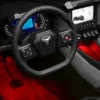 2884806_alt1_red_desaturated Modern car interior with illuminated red footwell and digital dashboard.