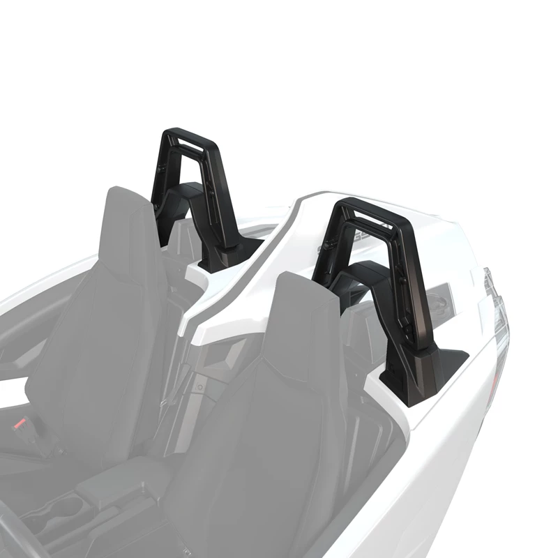 Two black and white seats with roll bars in a vehicle.