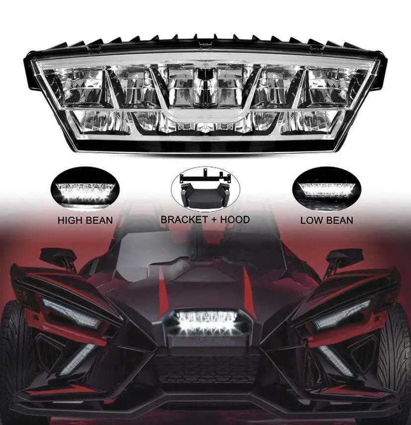 IMG_7221 A sleek, red three-wheeled vehicle with bold LED headlights and angular design.