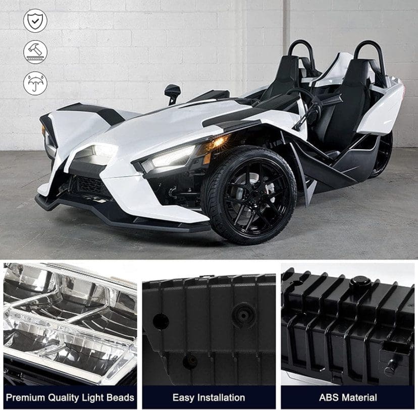 IMG_7224 White three-wheeled sports car with black accents and detailed headlight components.