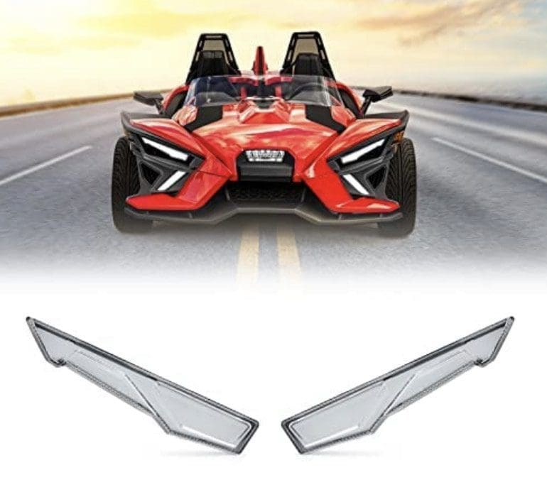 Red sports car driving on a road with two car side mirror covers.