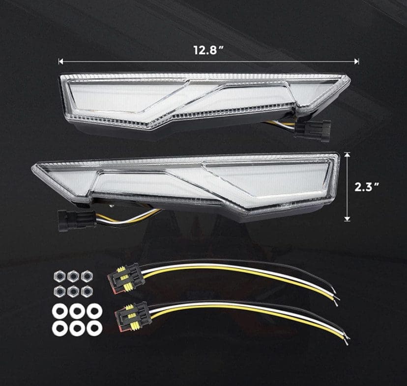 Two clear automotive tail light covers with mounting hardware and wiring.