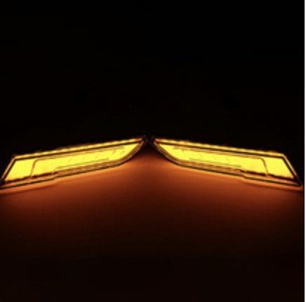 Symmetrical yellow lights glowing against a dark background.
