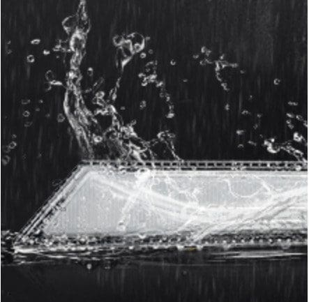 Black and white aerial view of a water body with a dock and boats.