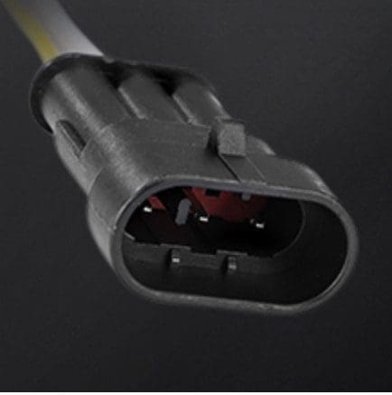 Close-up of a black electrical connector plug with three pins.