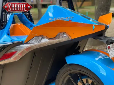 The back hood of a blue and orange Slingshot model