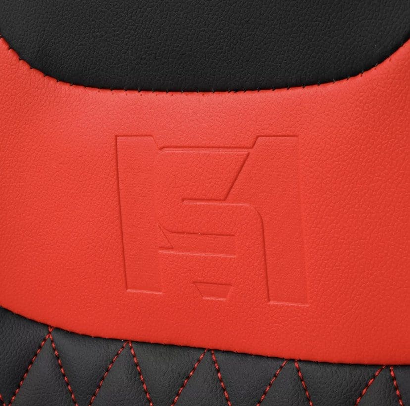 Close-up of red and black leather with embossed logo and red stitching.