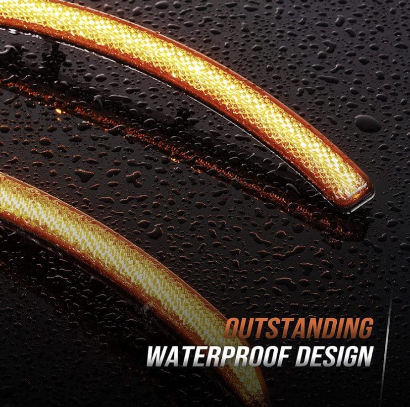 Close-up of a water-resistant zipper with water droplets.