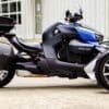 IMG_5314 A sleek Can-Am three-wheeled motorcycle parked on concrete outside a building.