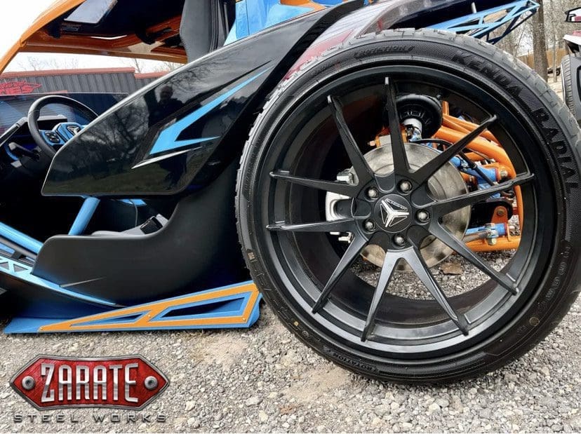 Close-up of a high-performance car's front wheel and brake system.