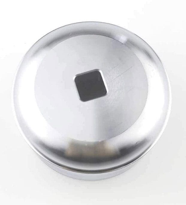 Metallic round object with a square hole in the center on a white background.
