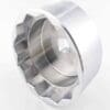A metal tool with a ridged, circular shape and square hole in the center.