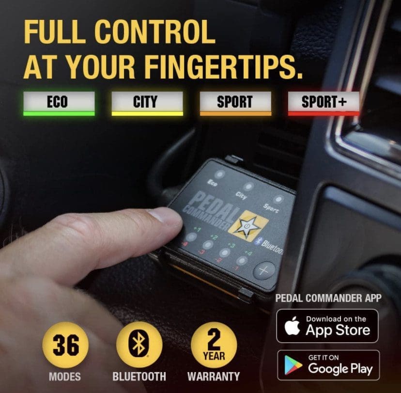 Hand holding a smartphone displaying a control app for a vehicle with various driving modes.