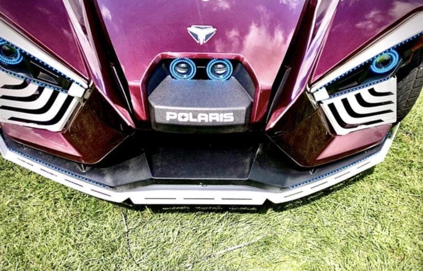 Close-up of a Polaris vehicle's front with distinctive headlights and grille.