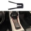 Car interior showing gear shift area with a nearby plastic trim piece.
