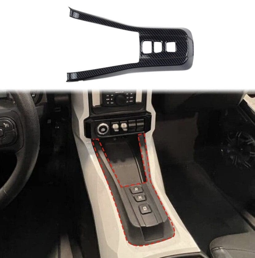 Car interior showing gear shift area with a nearby plastic trim piece.
