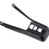Black carbon fiber car center console cover with cutouts.