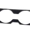 Carbon fiber car cup holder trim with two circular openings.