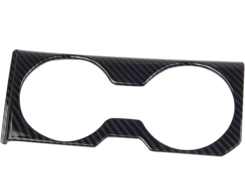 Carbon fiber car cup holder trim with two circular openings.