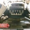 Close-up of a Polaris vehicle with a custom Zarate Steel Works logo and aggressive teeth design.