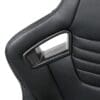 Close-up of a black car seat with a silver seatbelt buckle.