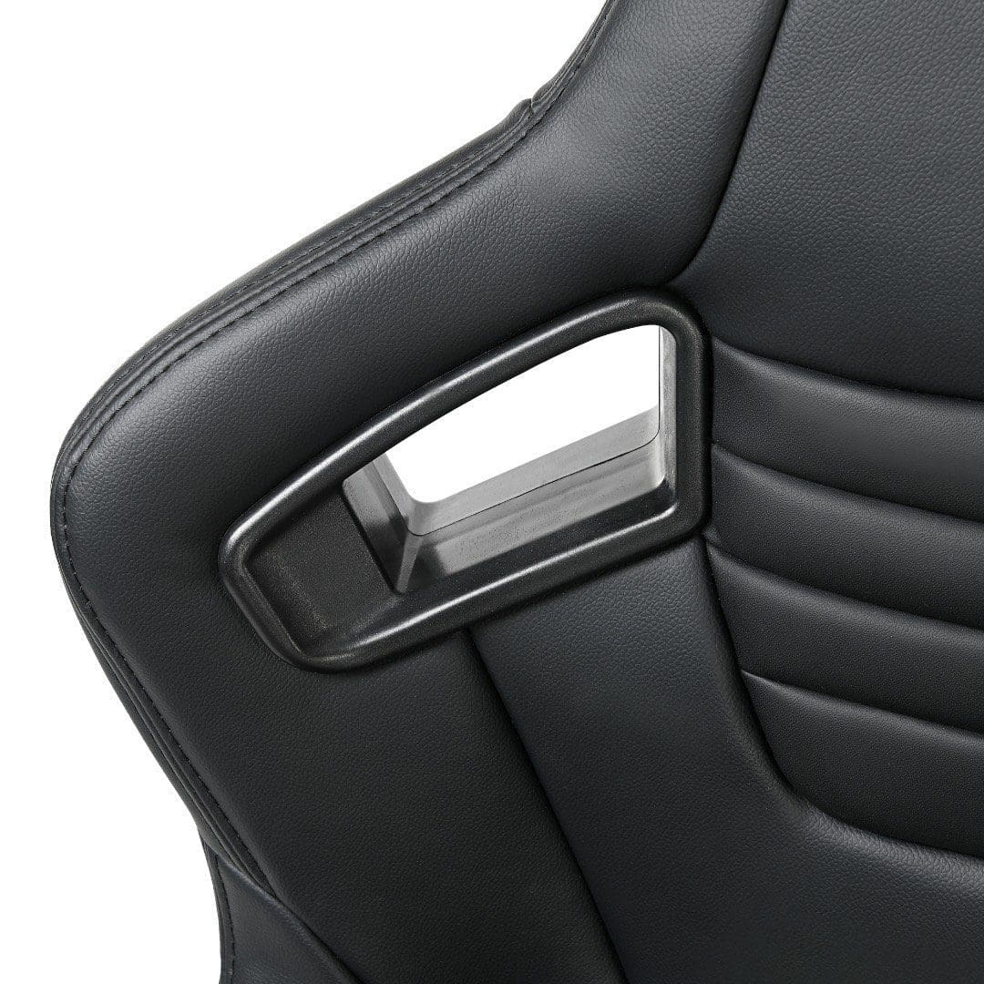 Close-up of a black car seat with a silver seatbelt buckle.