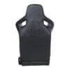 Black racing car seat with ergonomic design and harness slots.