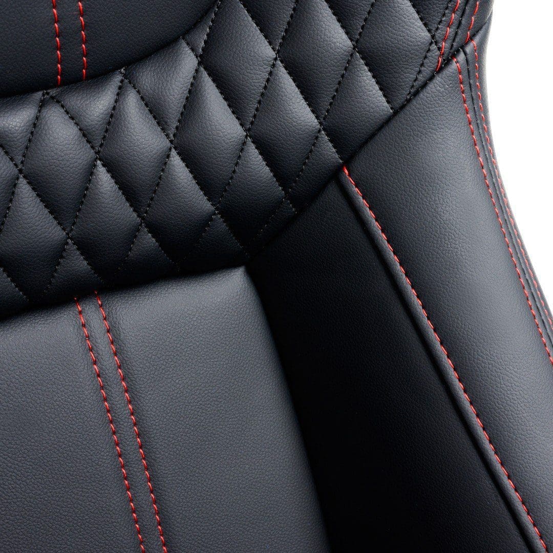Close-up of black leather car seat with red stitching.