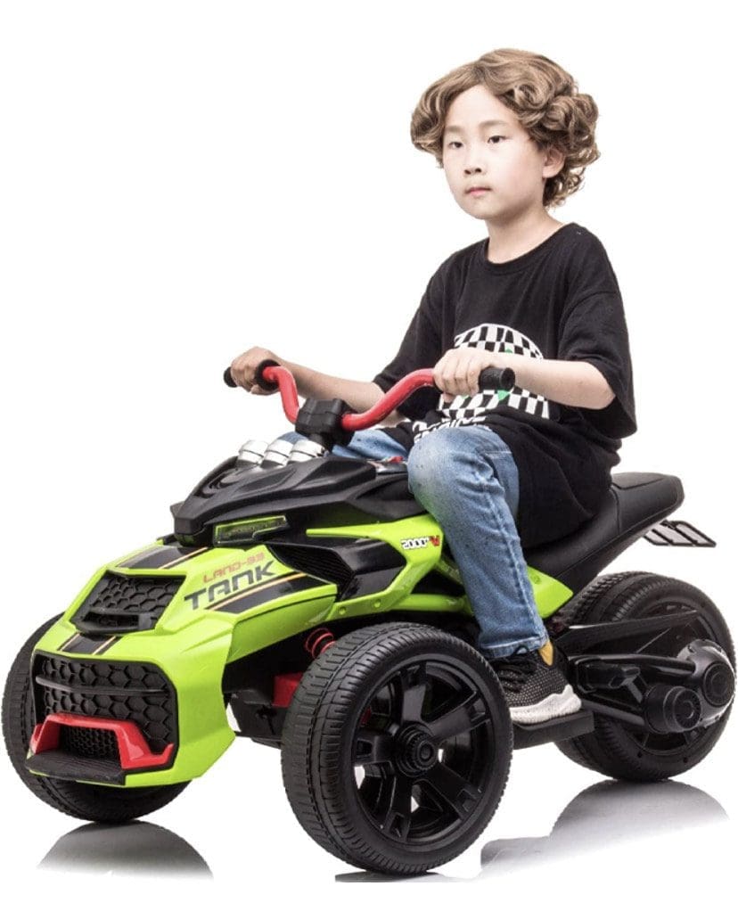 Young boy riding a green and black electric toy quad bike.