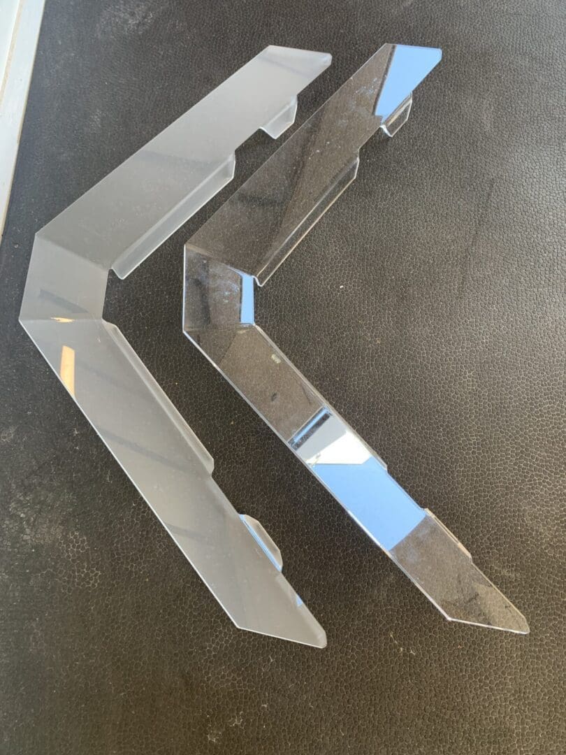 Two large metal brackets on a concrete floor.