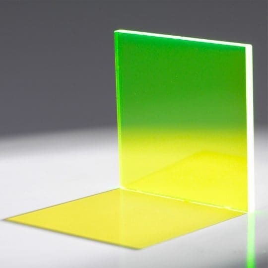 A glowing translucent panel with a gradient from green to yellow, casting a colorful shadow.