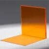 An orange L-shaped object with a flat surface and a vertical panel.