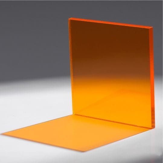 An orange L-shaped object with a flat surface and a vertical panel.