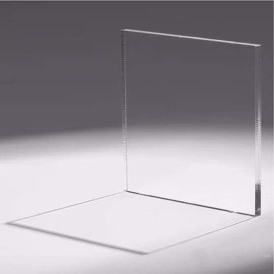 A transparent glass panel casting a shadow on a gray surface.