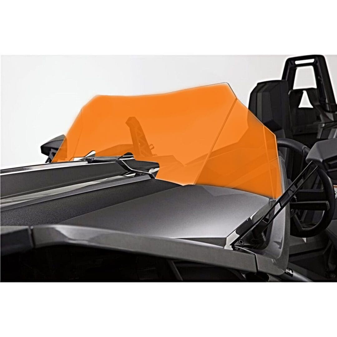 A sleek black race car with an orange wind deflector behind the driver's seat.