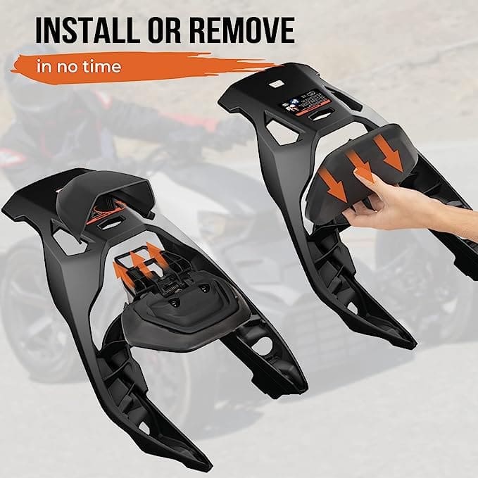 Two black snow chains being installed or removed on tires.