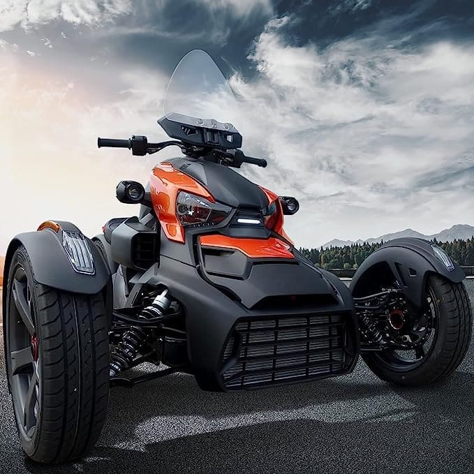 A sleek orange and black three-wheeled motorcycle under a dramatic sky.