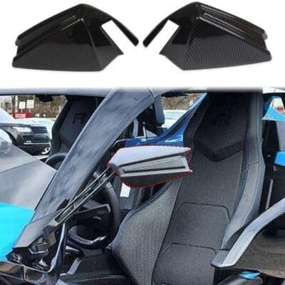 Black side mirror covers on a car with an open door.