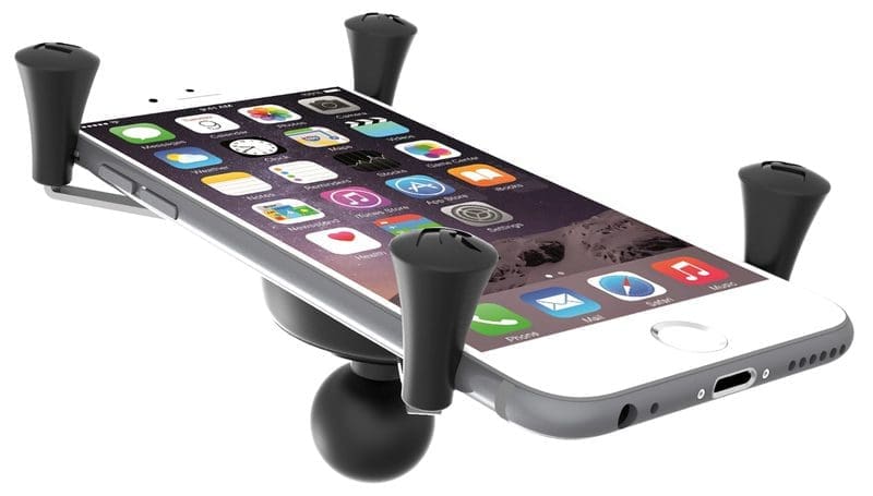 Smartphone mounted on a car vent holder with adjustable grips.