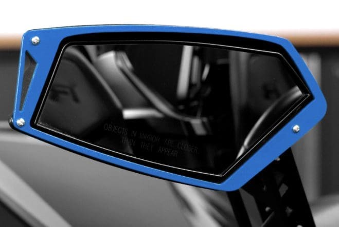 Close-up of a sleek blue and black car side mirror.