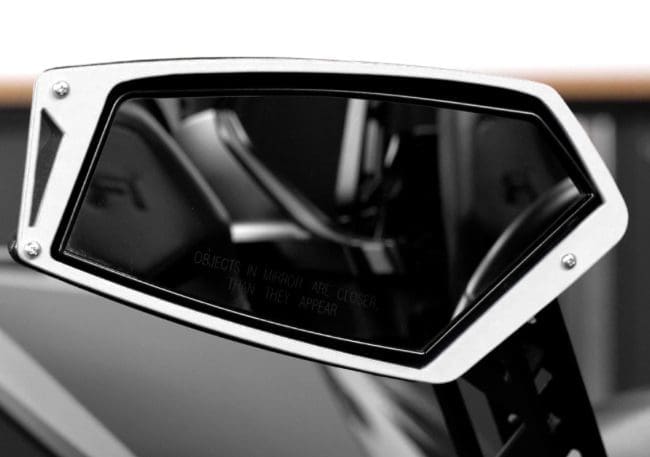 Close-up of a sleek car side mirror with a modern design.