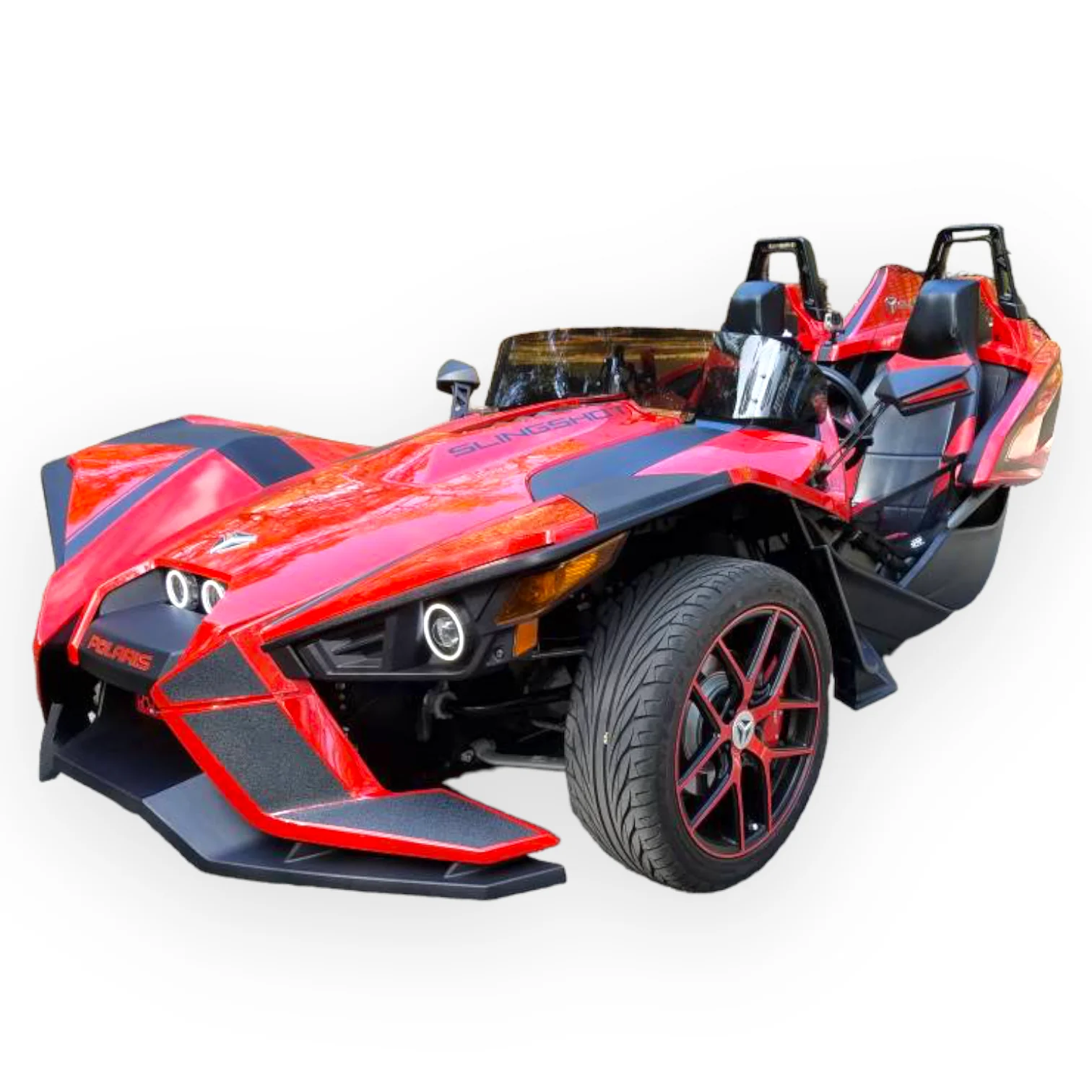 A sporty, open-top three-wheeled car with red and black design.