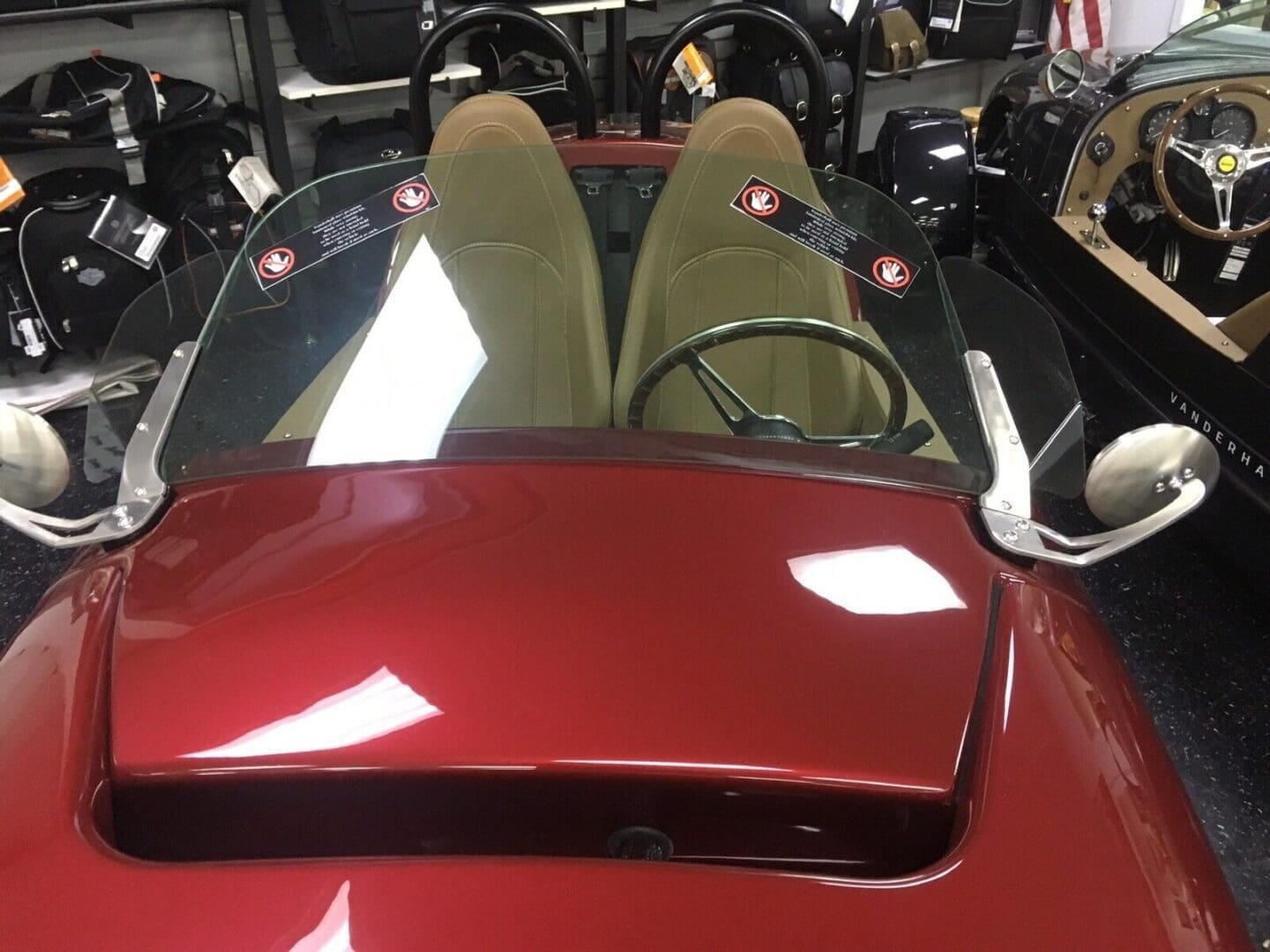 Vintage red sports car interior with two seats and a simple dashboard.