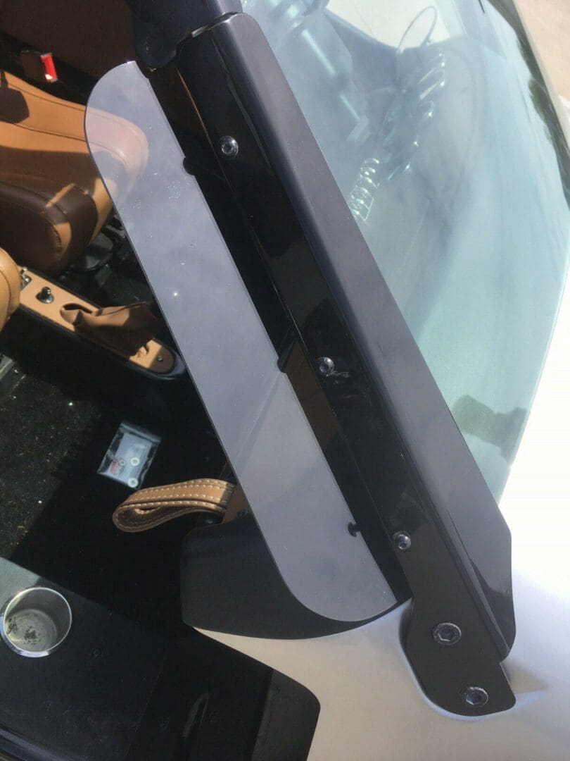 Close-up of a car's windshield wiper and hood area.
